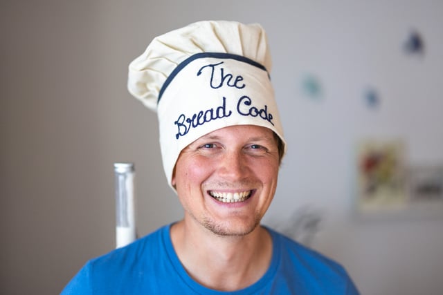 Hendrik smiling, chef hat that says The Bread Code
